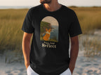 Black t-shirt with a corgi looking out at cliffs and sea, "Paws And Reflect" text.