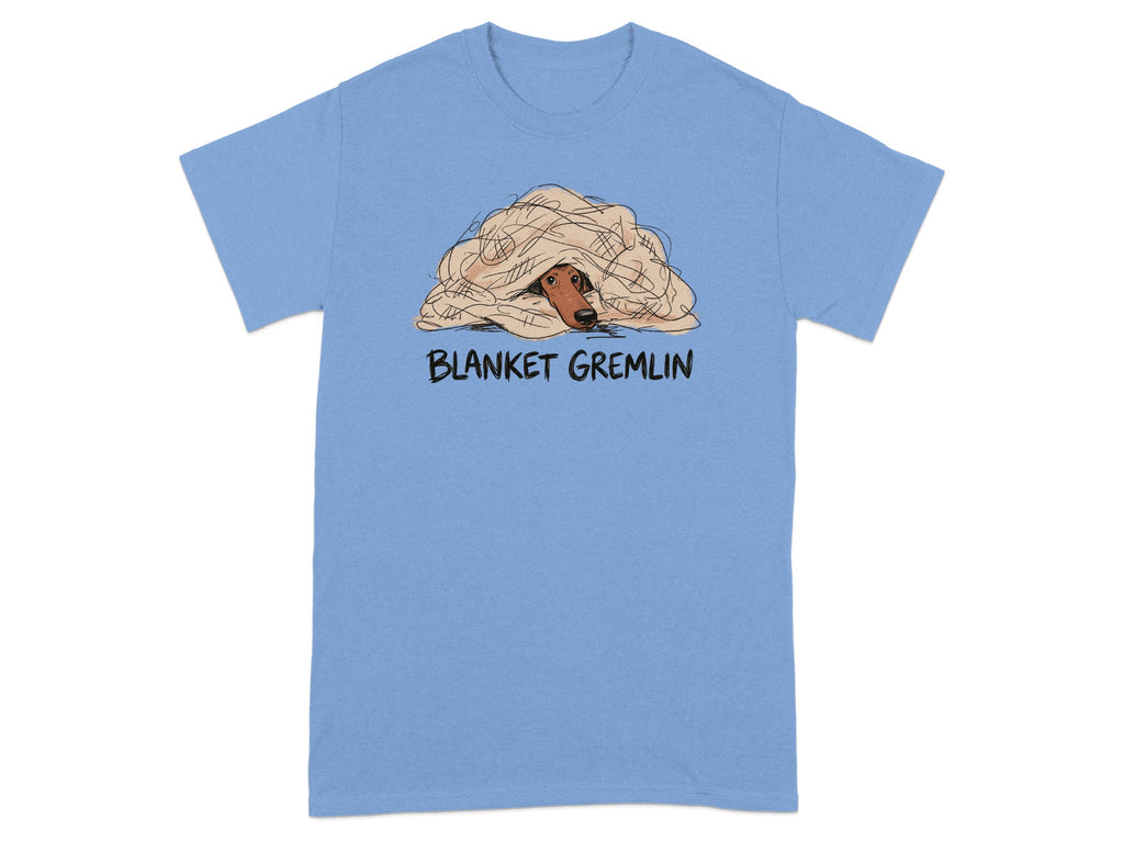 T-shirt with cartoon dog peeking out from a blanket, labeled "BLANKET GREMLIN".