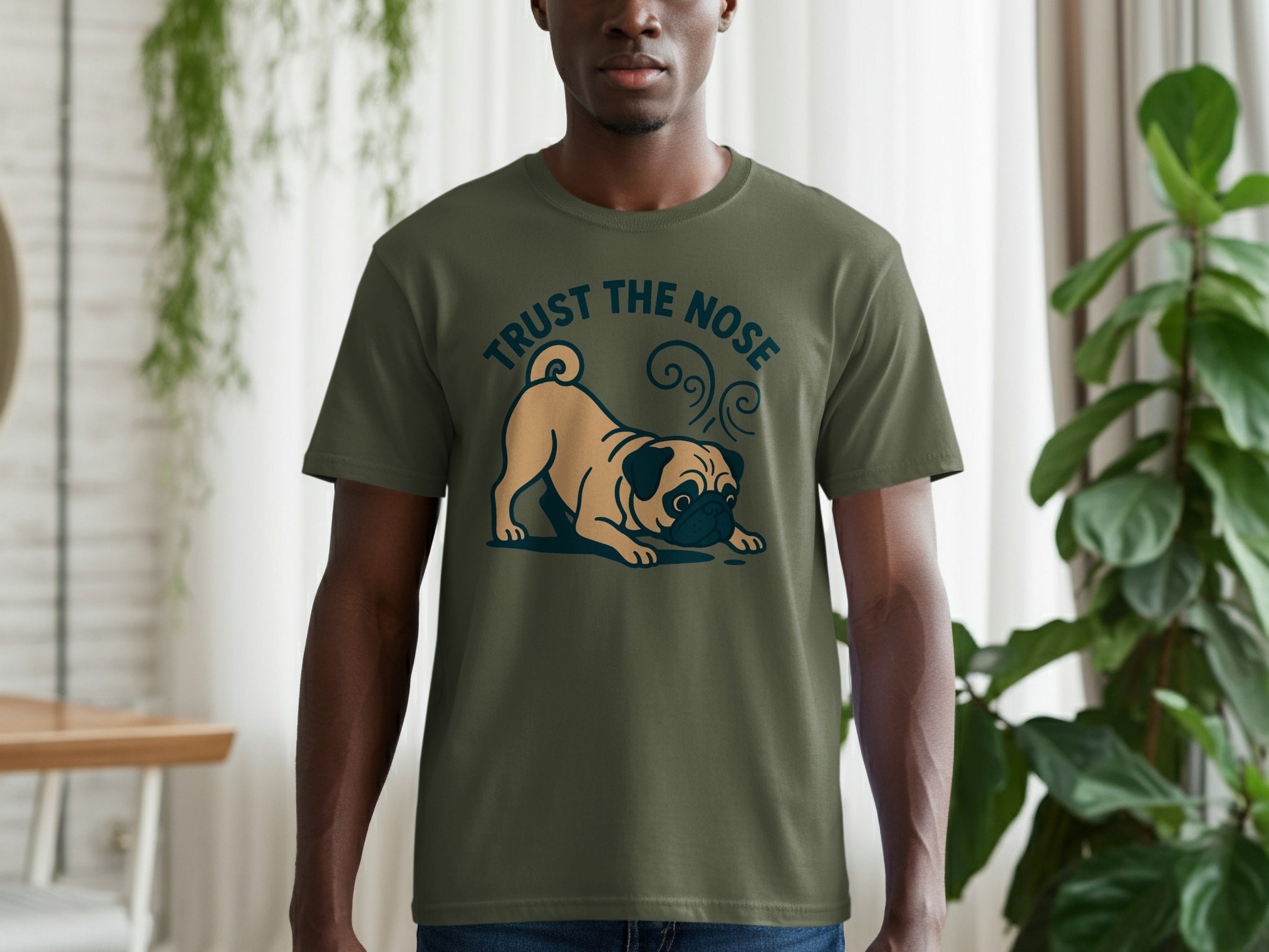 Khaki pug on olive green shirt with "TRUST THE NOSE" text.