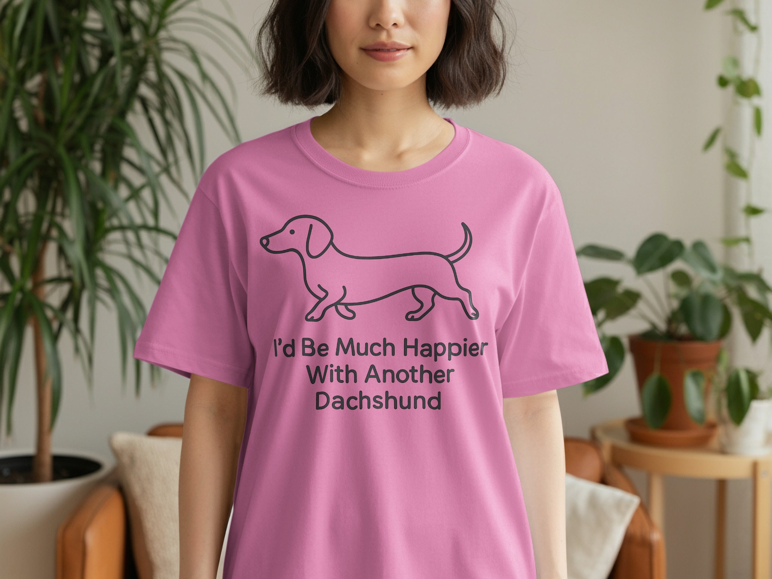 Pink t-shirt with a line drawing of a dachshund and text.
