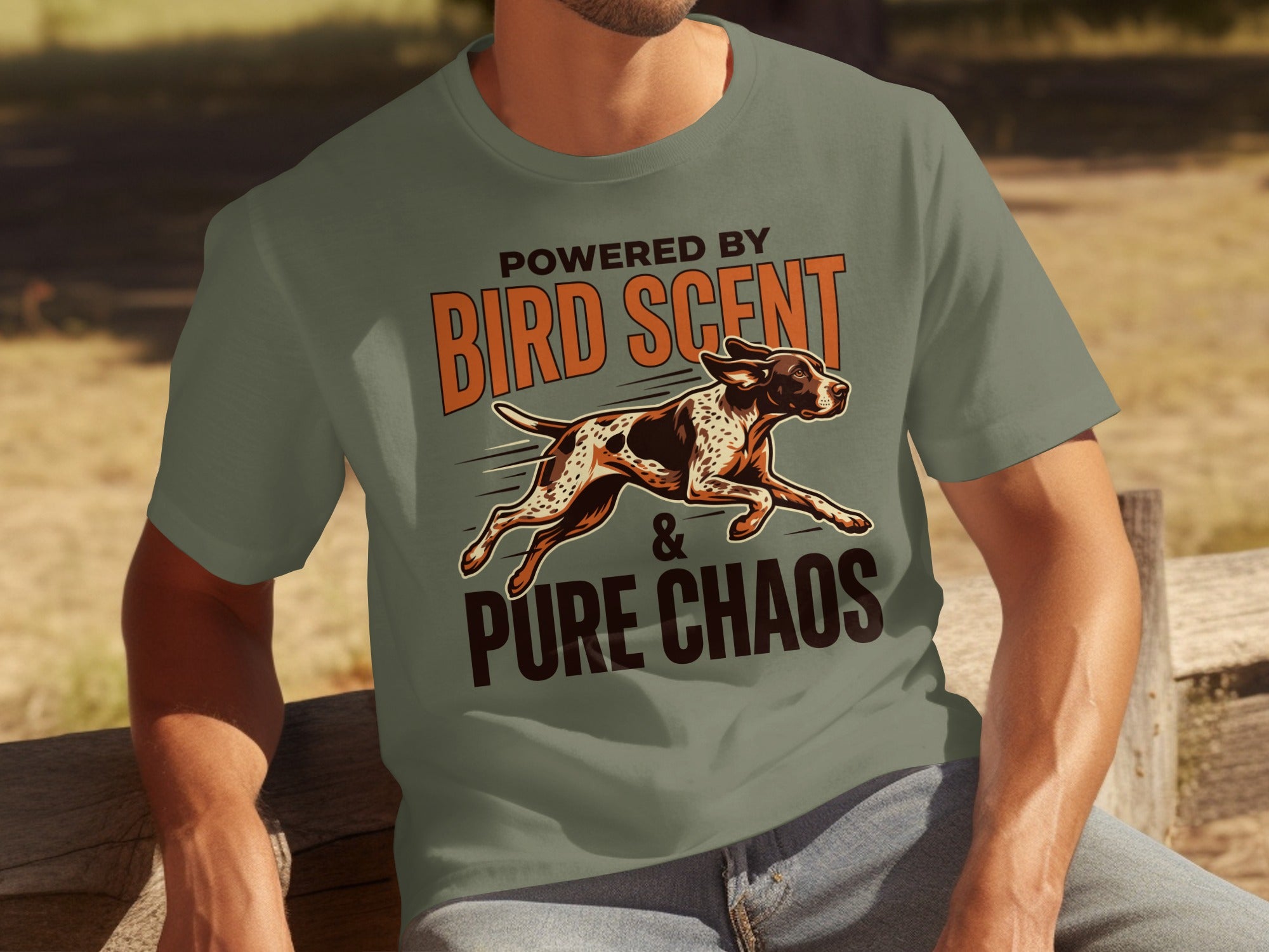 Green t-shirt with "Powered by Bird Scent & Pure Chaos" and a running dog.