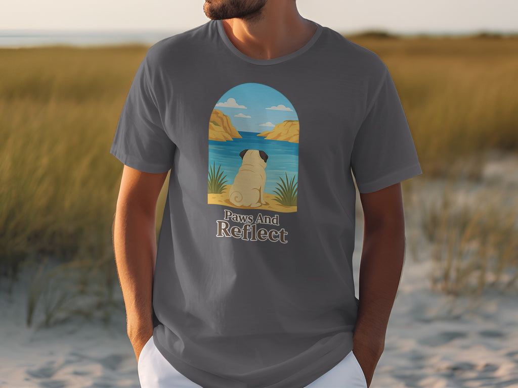 Graphic tee with a pug looking at water and text "Paws And Reflect".