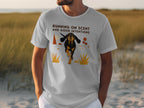 White t-shirt with a graphic of a dog running through grass.