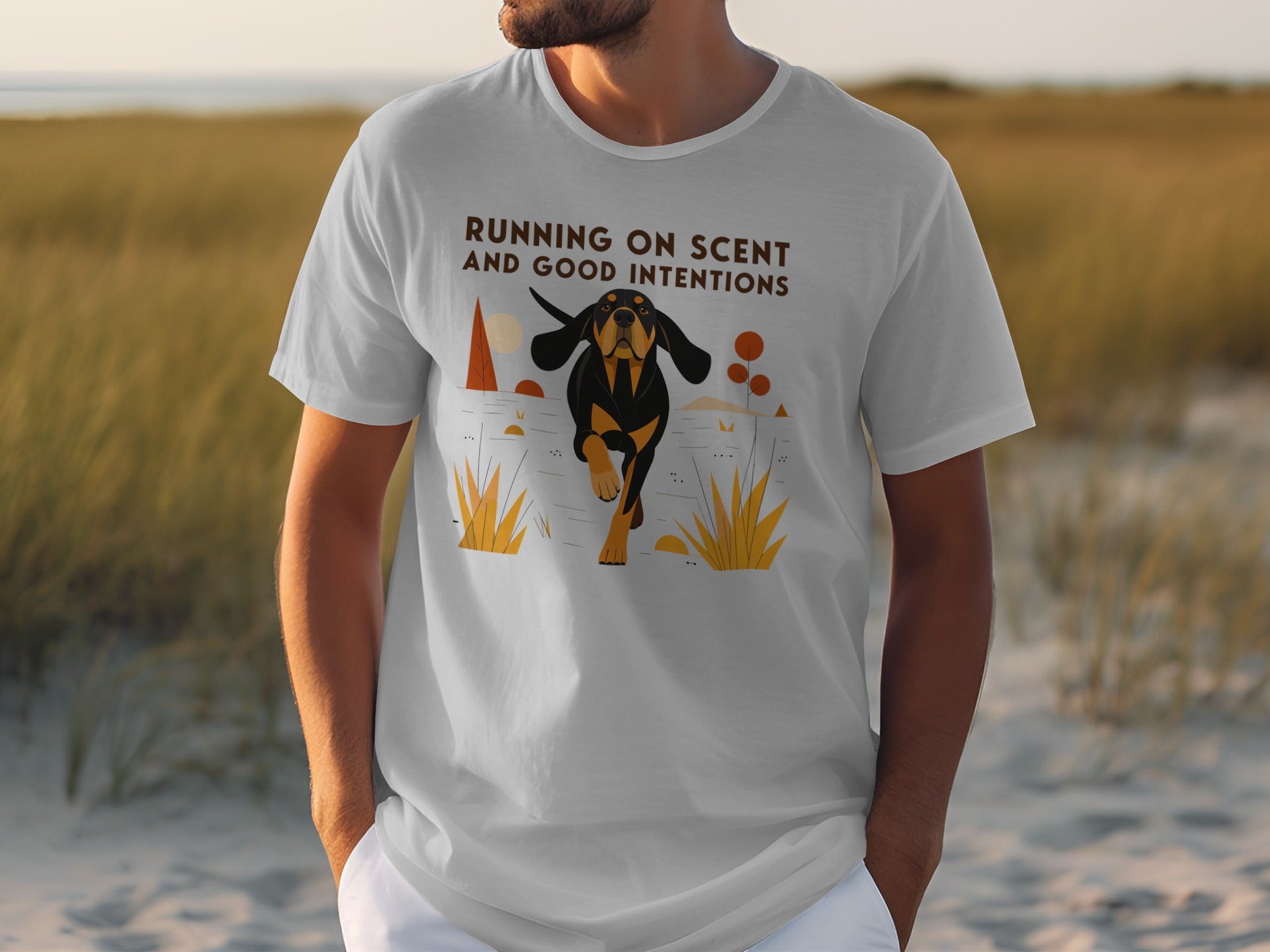 White t-shirt with a graphic of a dog running through grass.
