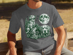 Three dogs and a moon in a dark green sketch on a gray t-shirt.