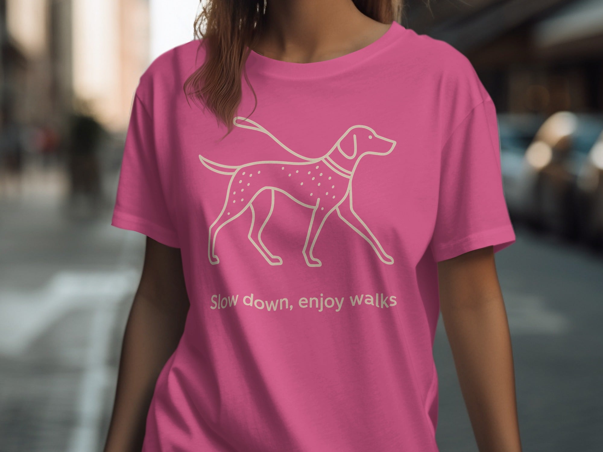 Pink t-shirt with outline of dog and text "Slow down, enjoy walks".