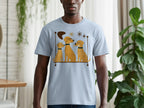 Light blue t-shirt with a graphic of three yellow dogs sitting on a shelf, one wearing glasses.