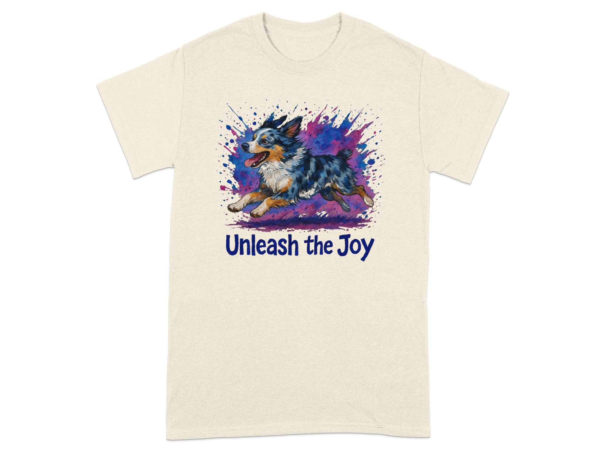 Cream t-shirt with a watercolor Australian Shepherd running through a colorful splash with text "Unleash the Joy".