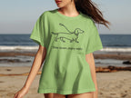 Light green t-shirt with a dachshund outline and "Slow down, enjoy walks" text.