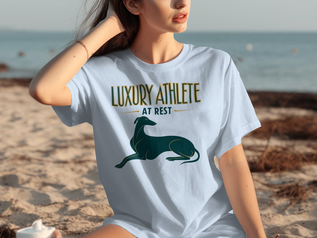 Light blue t-shirt with "LUXURY ATHLETE AT REST" and a greyhound graphic.