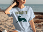 Light blue t-shirt with "LUXURY ATHLETE AT REST" and a greyhound graphic.