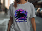 Black dog running against colorful ink splash with "Unleash the Joy" text.