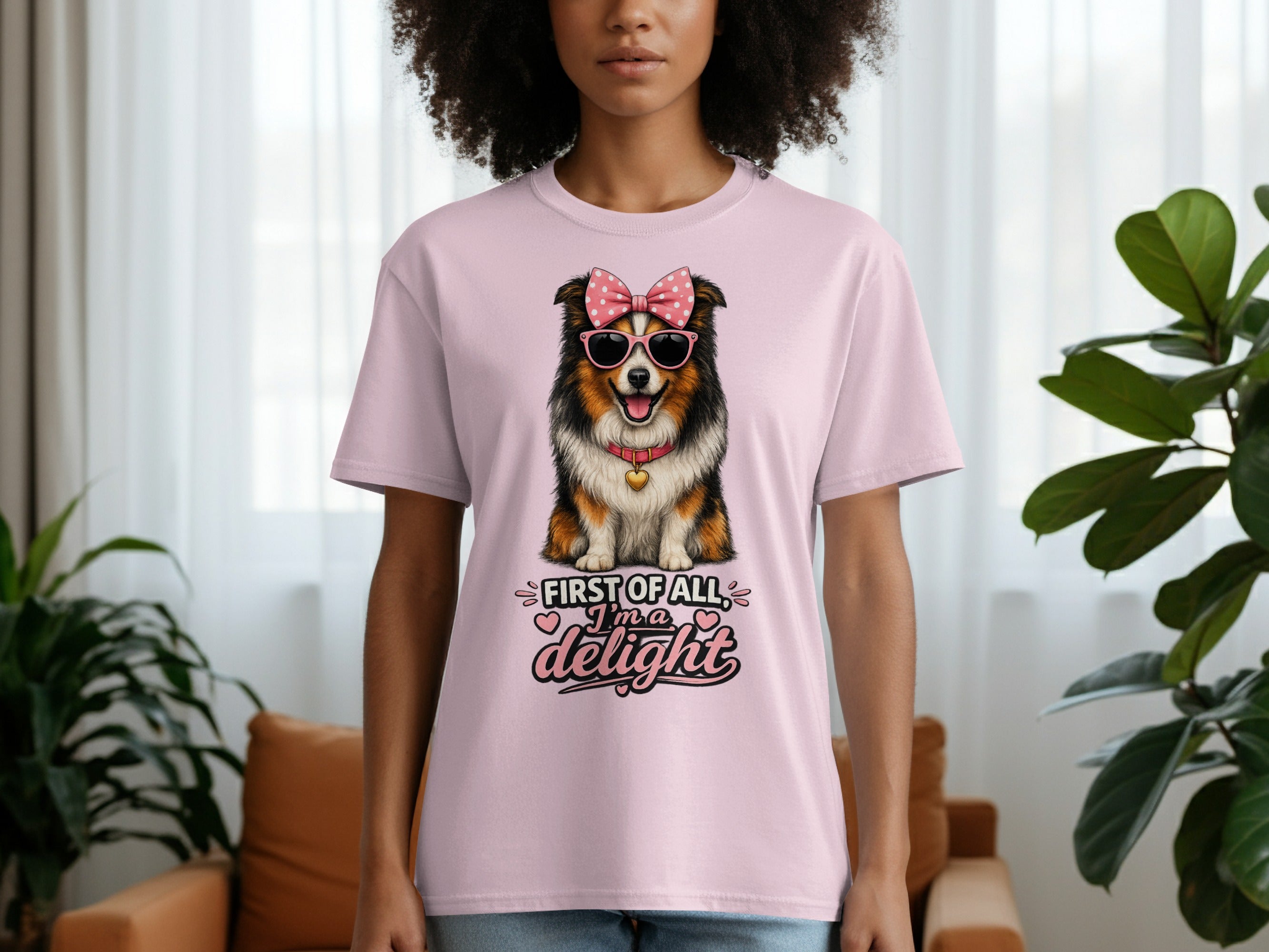 Pink t-shirt with a dog wearing a bow and sunglasses, saying "First of all, I'm a delight."