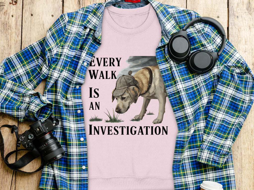 Pink sweatshirt with dog investigation graphic and plaid shirt.