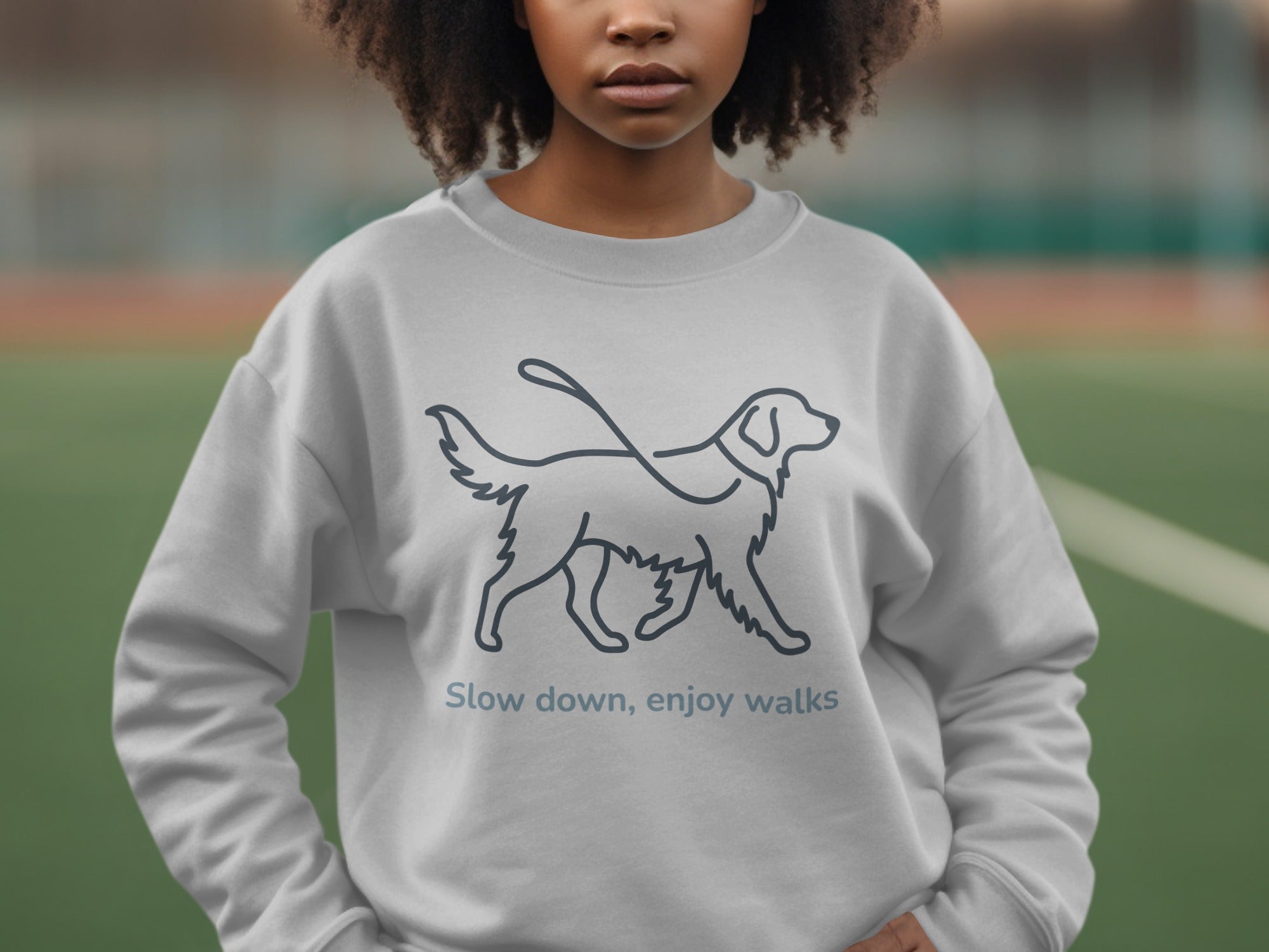Grey sweatshirt with a dog outline and text "Slow down, enjoy walks."