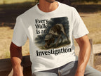 White t-shirt with a dog wearing a detective hat and text "Every Walk Is an Investigation."
