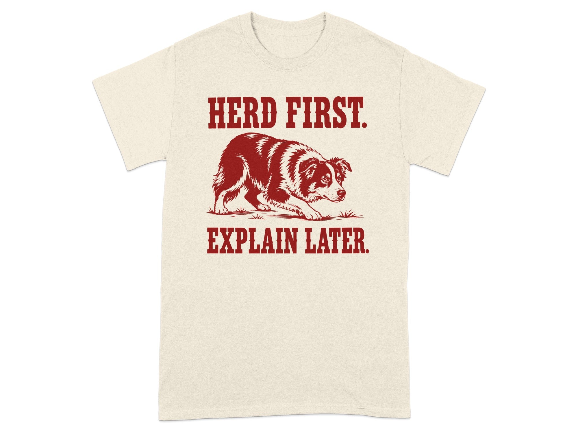 Cream t-shirt with red text "HERD FIRST. EXPLAIN LATER." and a dog graphic.