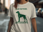 Green t-shirt with dog silhouette and text "CALM OUTSIDE. INTENSELY ATTACHED INSIDE."