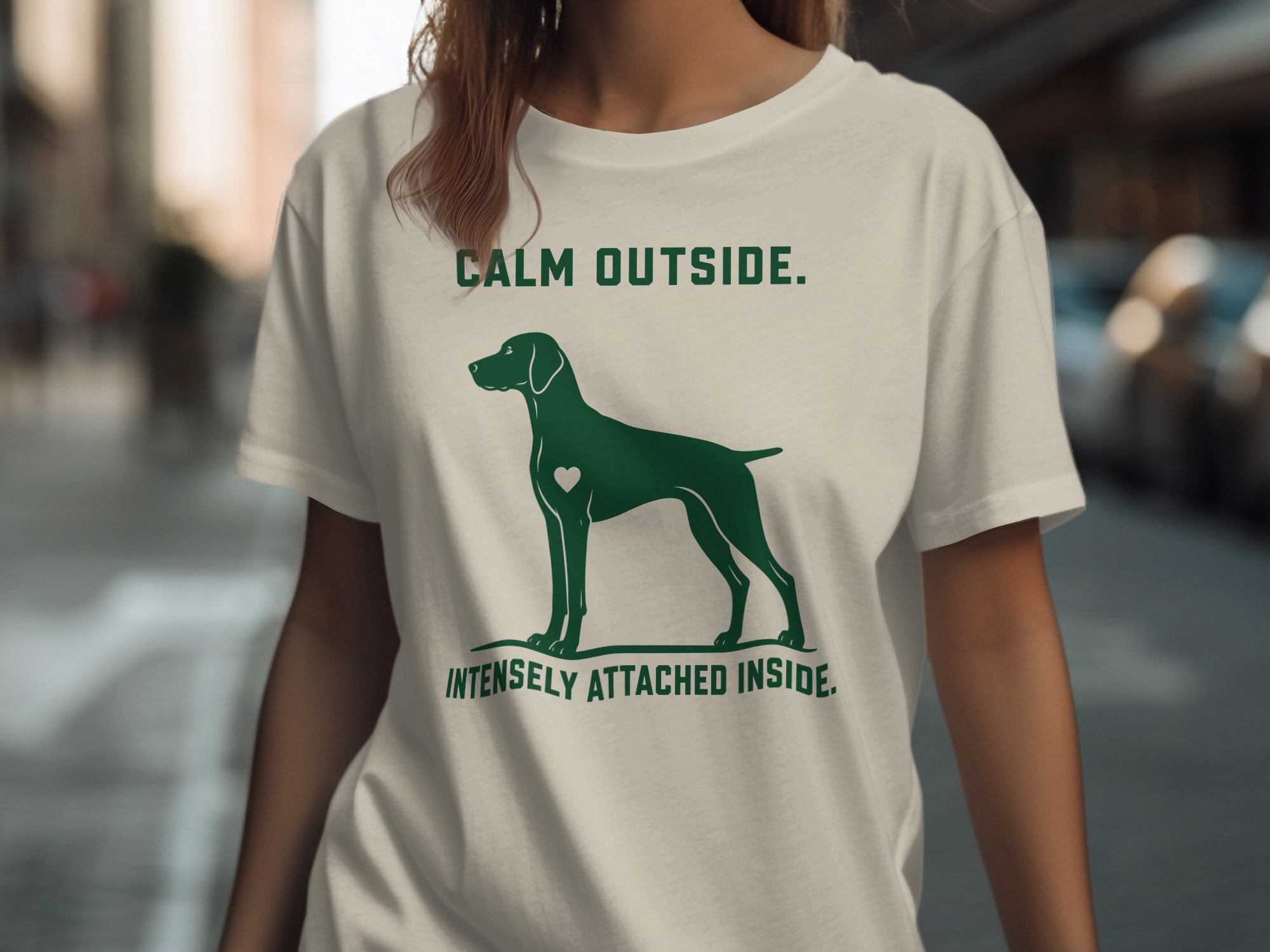 Green t-shirt with dog silhouette and text "CALM OUTSIDE. INTENSELY ATTACHED INSIDE."