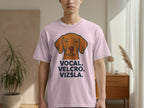 Light pink t-shirt with a Vizsla dog graphic and "VOCAL. VELCRO. VIZSLA." text.