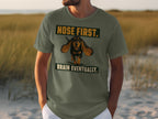 Green t-shirt with a dog graphic and text "NOSE FIRST. BRAIN EVENTUALLY."