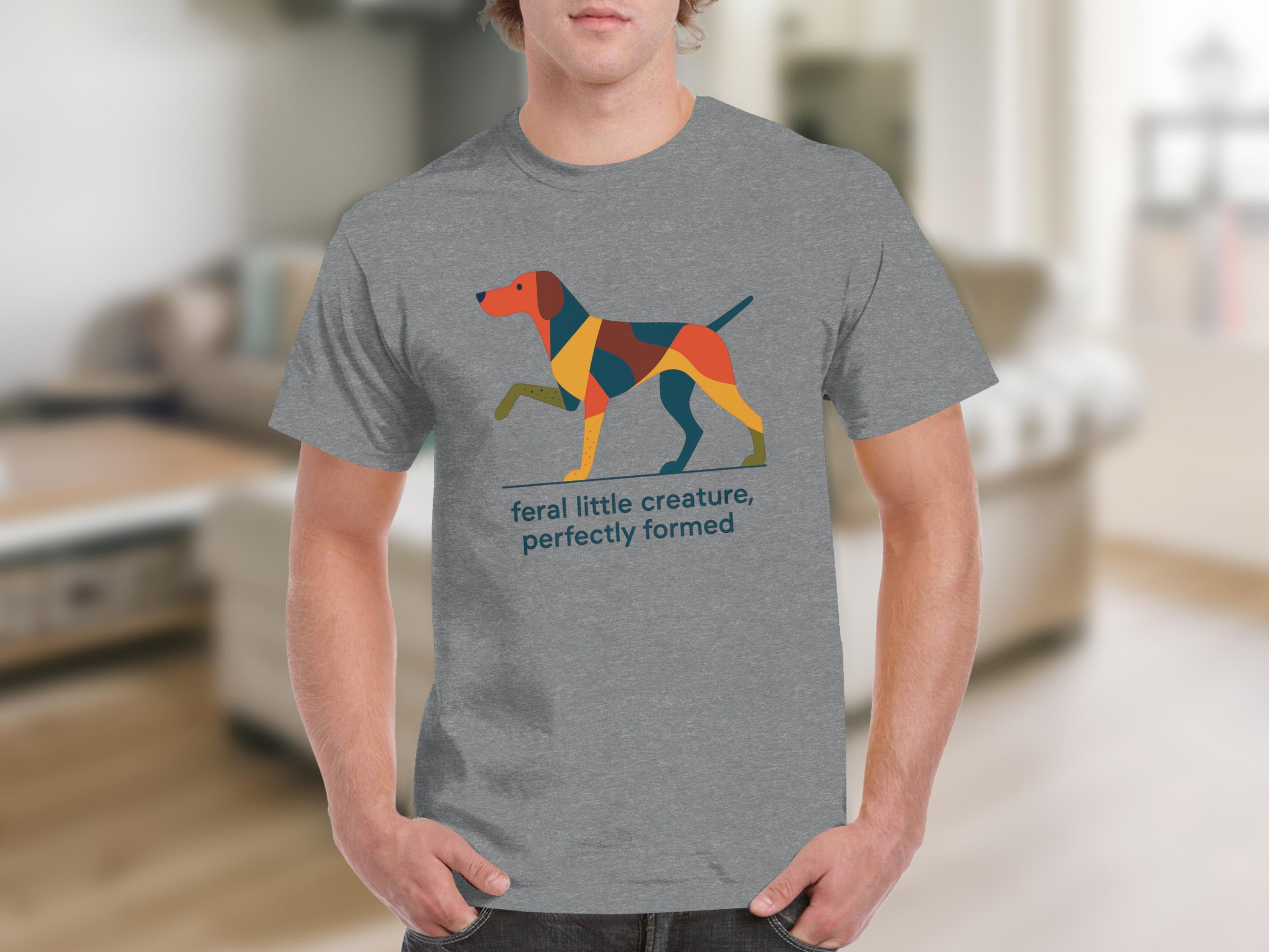 Grey t-shirt with a geometric dog illustration and text "feral little creature, perfectly formed".