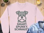 Light pink sweatshirt with a gray schnauzer dog face and text "SMART. SPUNKY. SCHNAUZY."