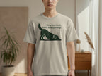 Light grey t-shirt with a silhouette of a dog sniffing the ground and text.