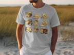 Cartoony golden retriever puppies interacting with books in various poses on a white t-shirt.
