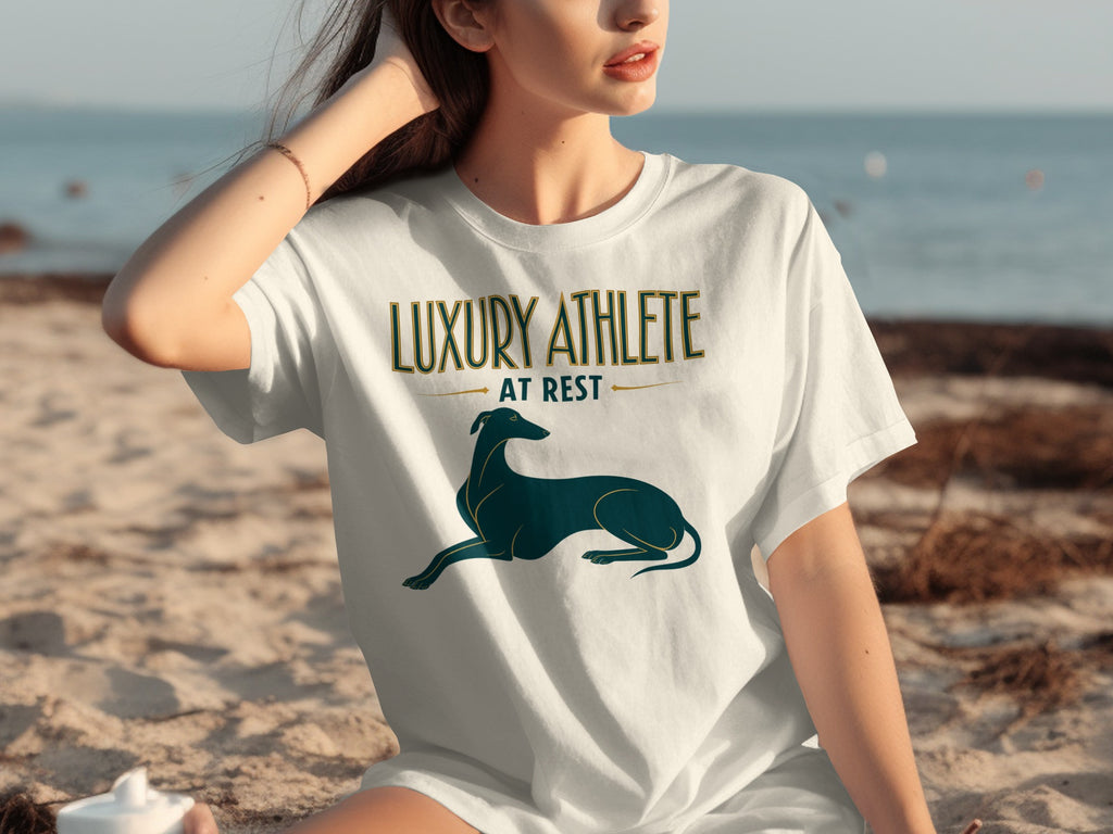 White t-shirt with gold text "LUXURY ATHLETE AT REST" and a black greyhound silhouette.