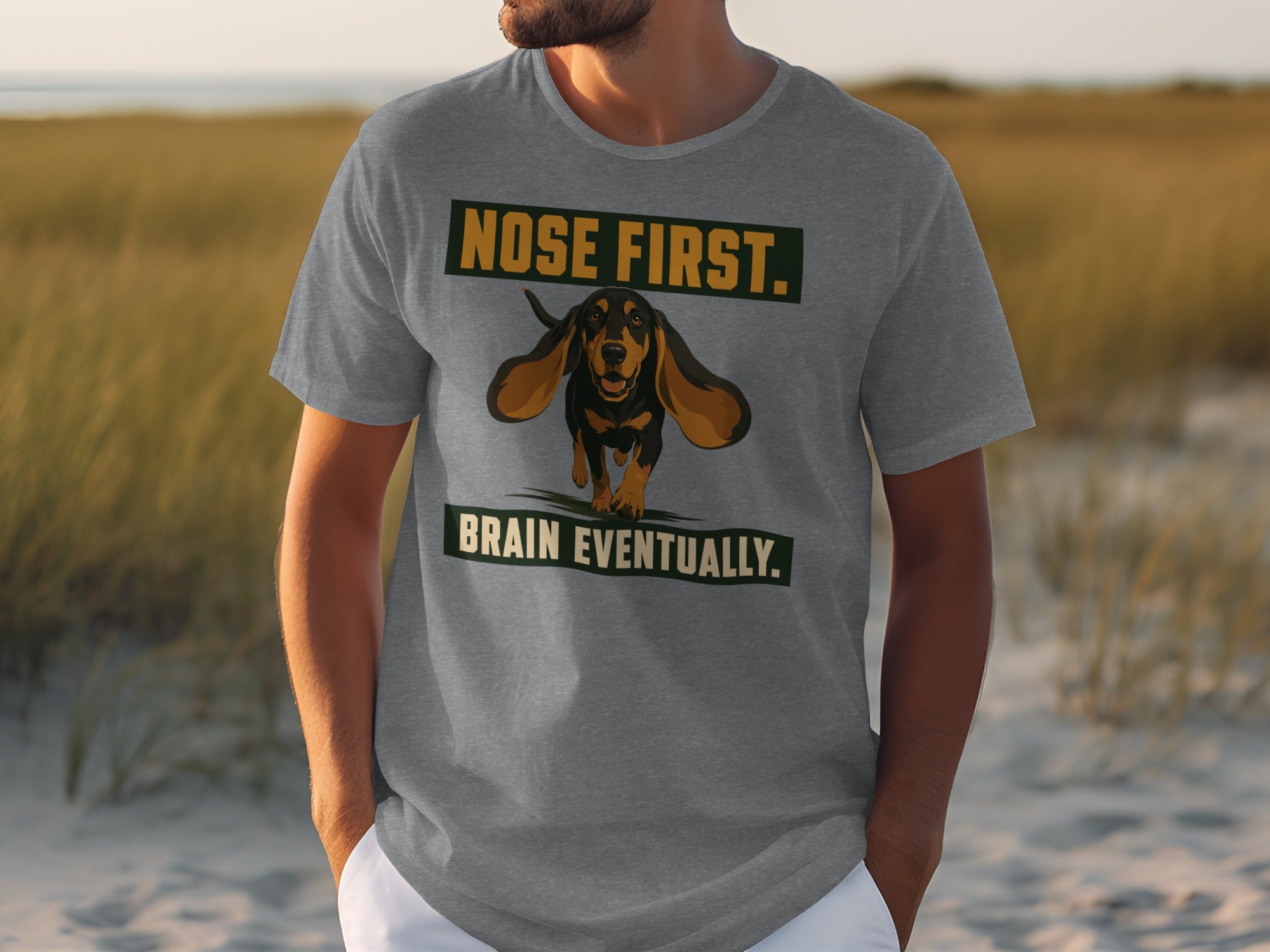 Grey t-shirt with a dachshund wearing a backpack, "Nose First. Brain Eventually."