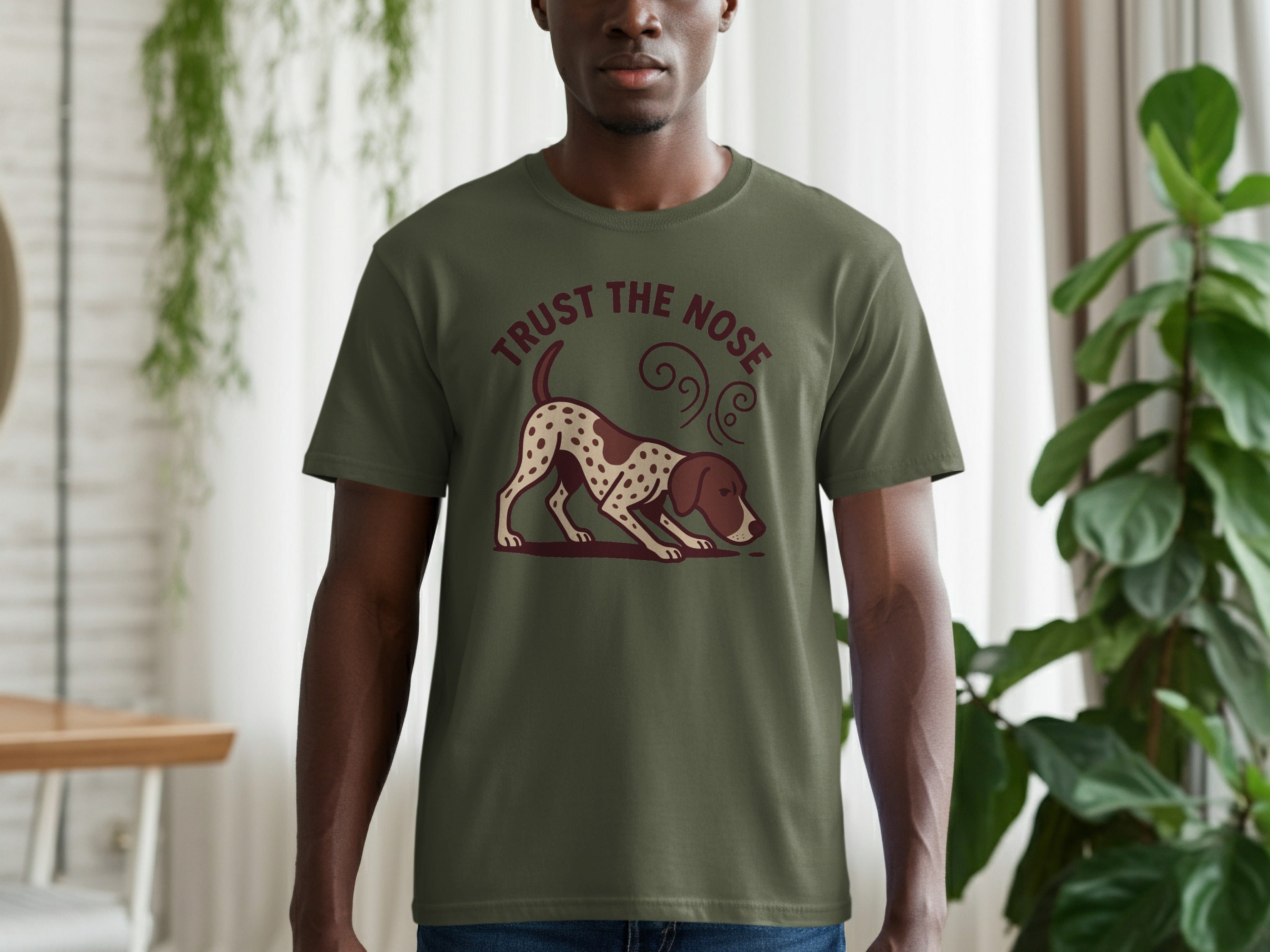 Green t-shirt with a hunting dog design and "TRUST THE NOSE" text.