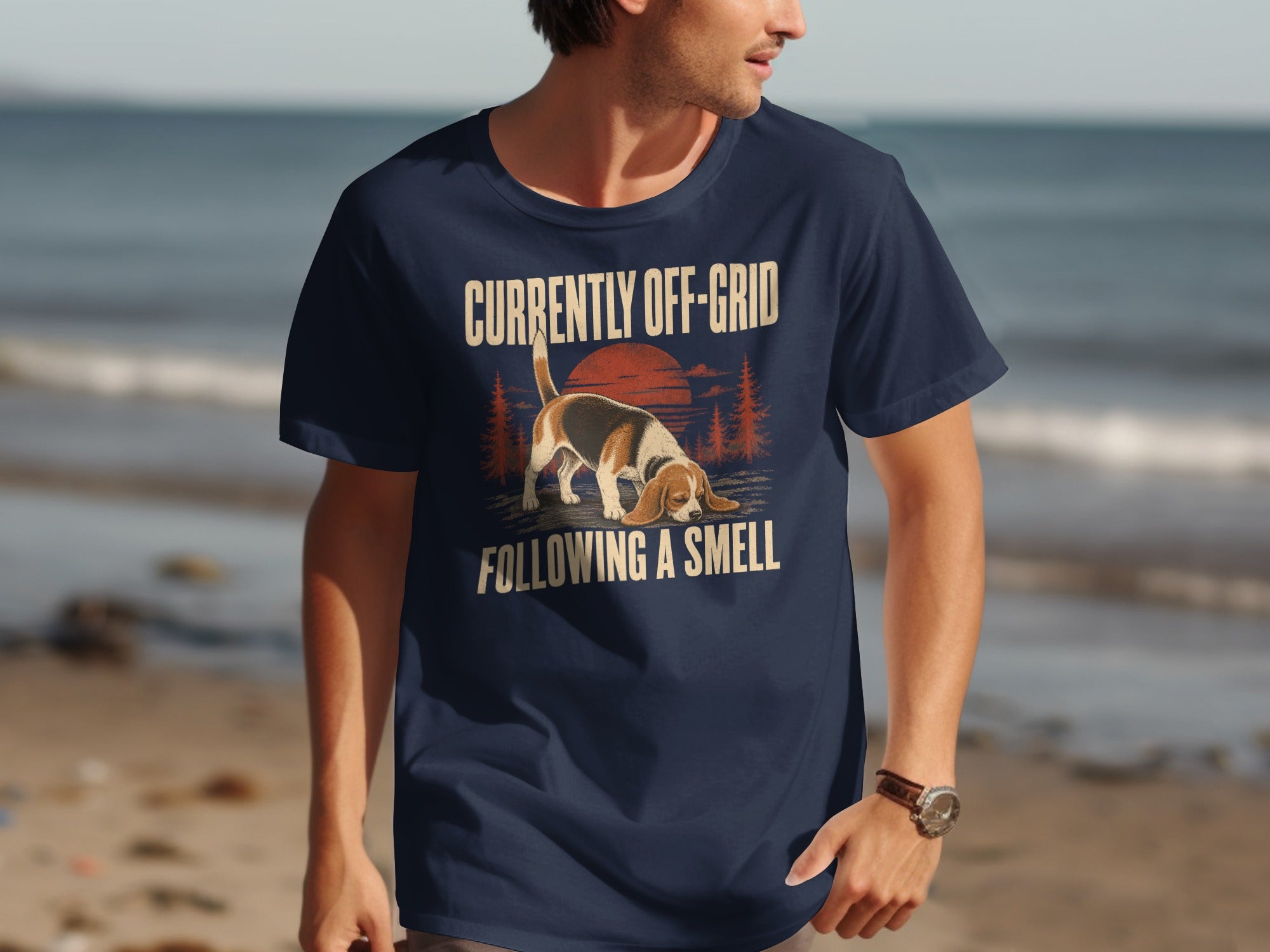 Navy t-shirt with beagle on beach, text "CURRENTLY OFF-GRID FOLLOWING A SMELL".
