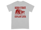 Grey t-shirt with red text and illustration of a dog herding.