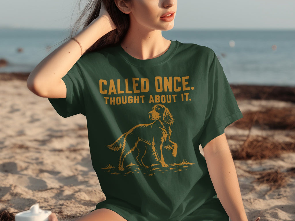 Dark green t-shirt with a dog graphic and "CALLED ONCE. THOUGHT ABOUT IT."