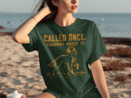 Dark green t-shirt with a dog graphic and "CALLED ONCE. THOUGHT ABOUT IT."