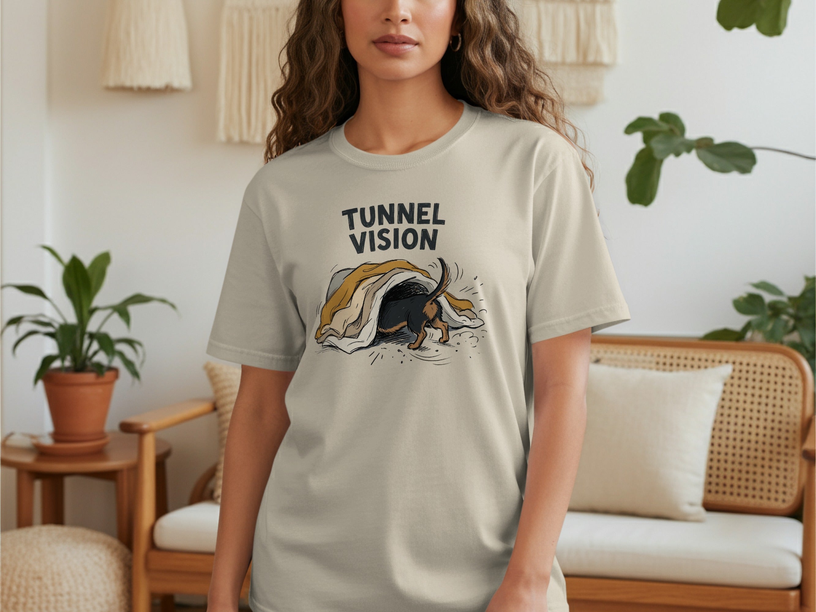 Light beige t-shirt with dachshund puppy crawling under a blanket.