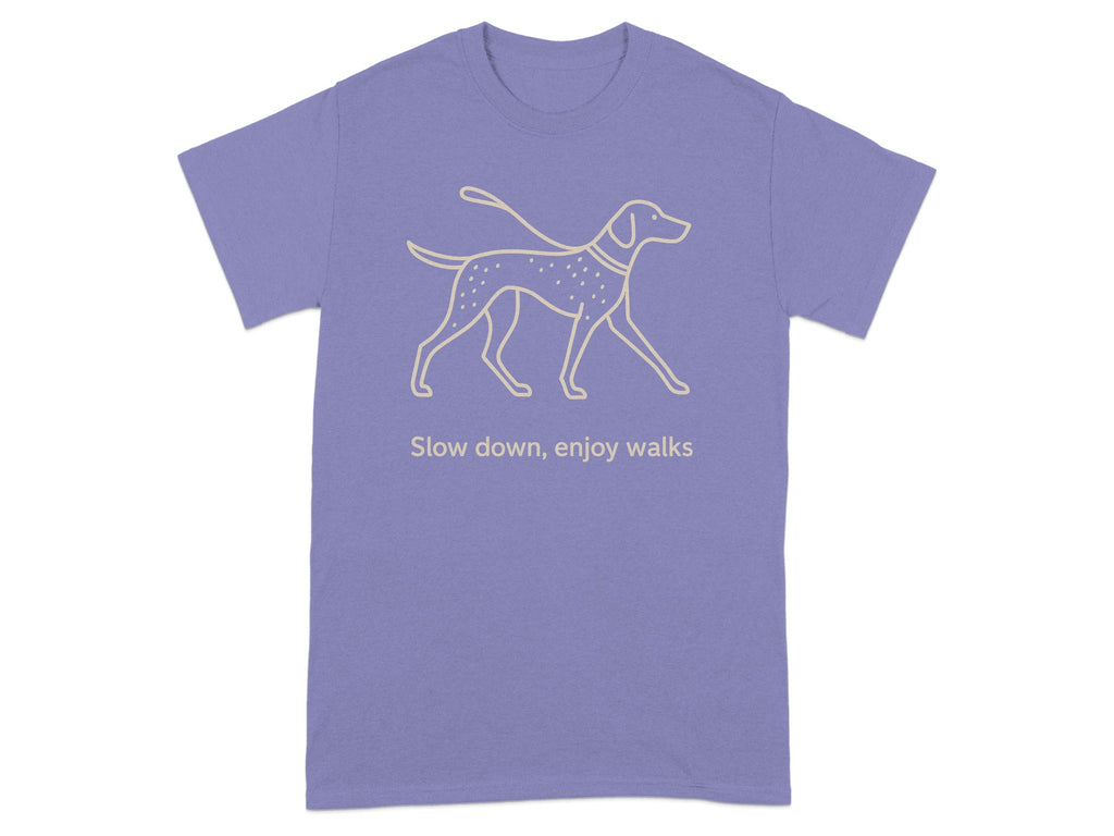Lavender t-shirt with a graphic of a dog on a leash and text reading "Slow down, enjoy walks".