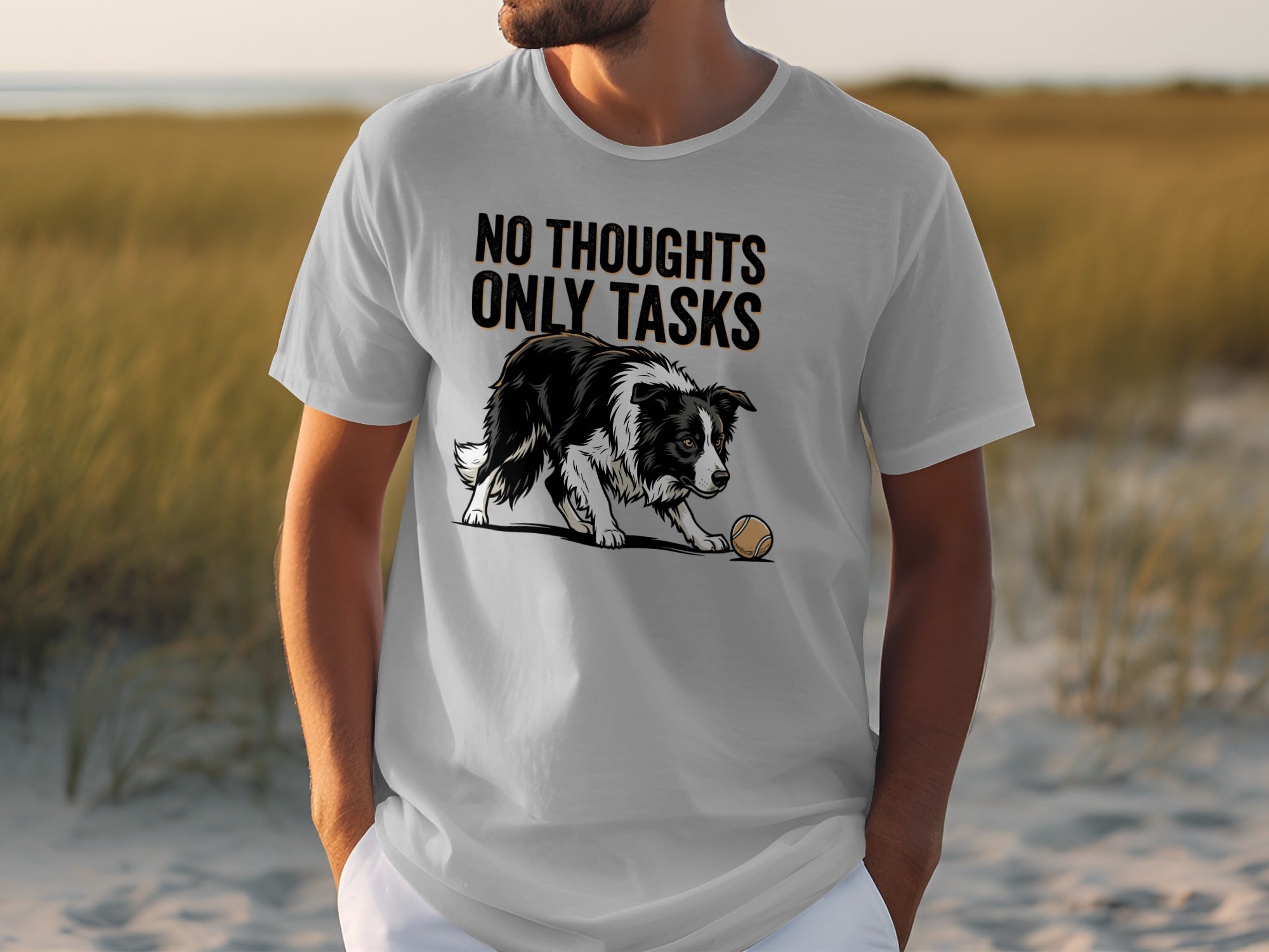 Man wearing a grey t-shirt with a border collie and tennis ball graphic.