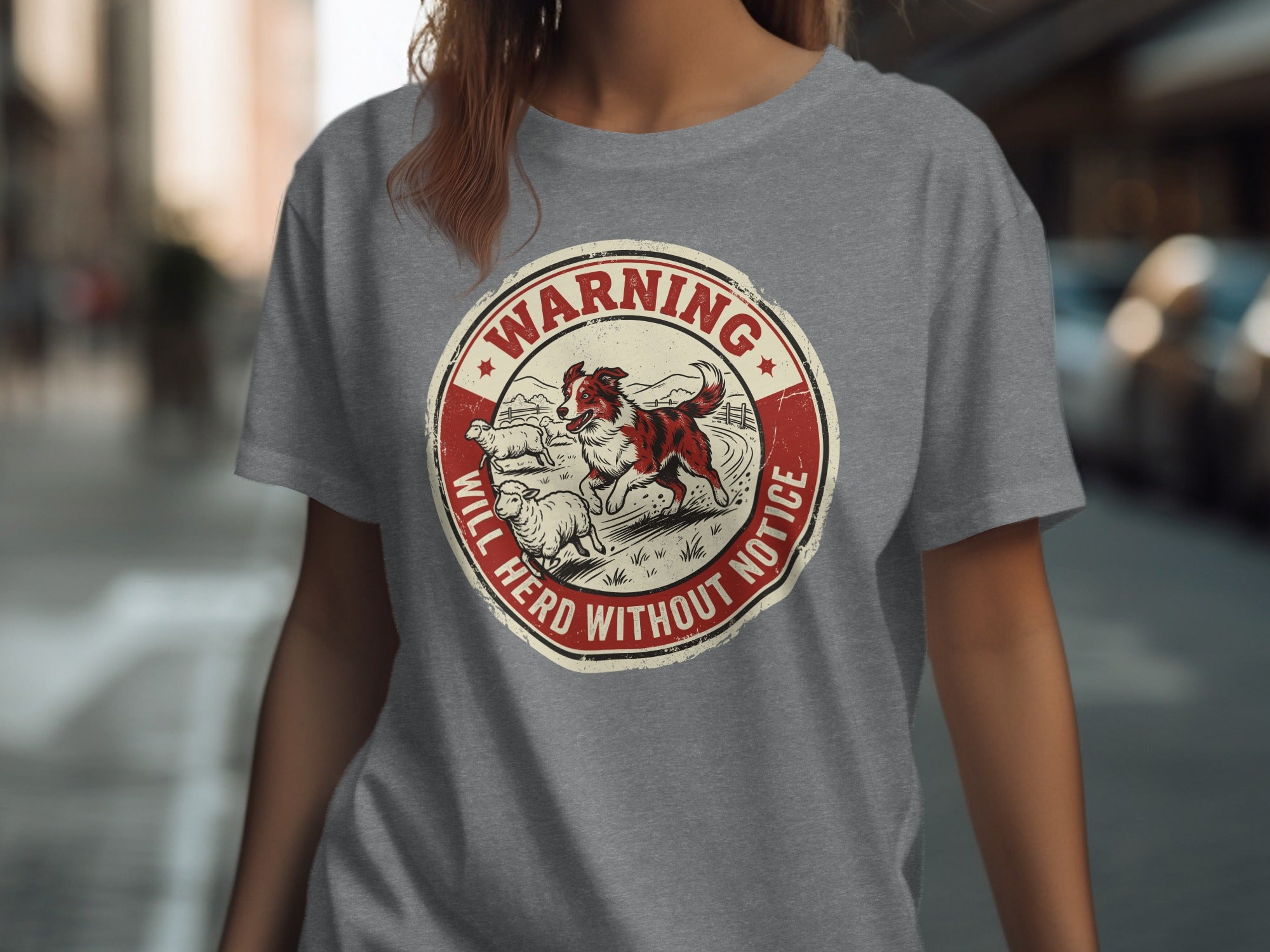 Circular graphic with a dog herding sheep, text reads "WARNING WILL HERD WITHOUT NOTICE".