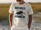 White t-shirt with "SLEEP ATHLETE. OCCASIONAL DOG." text and a dog graphic.