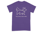 Purple t-shirt with a white outline of a corgi and the text "Slow down, enjoy walks."