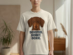 Cream t-shirt with a dachshund illustration and text "DEVOTED. DORKY. DOXIE."