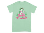 Mint green t-shirt with a dog on a bicycle wearing sunglasses.
