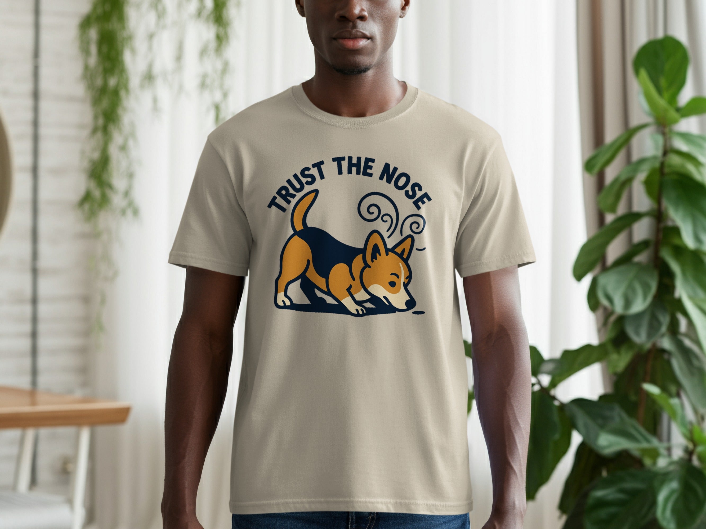 Beige t-shirt with a corgi graphic and text that says "TRUST THE NOSE".
