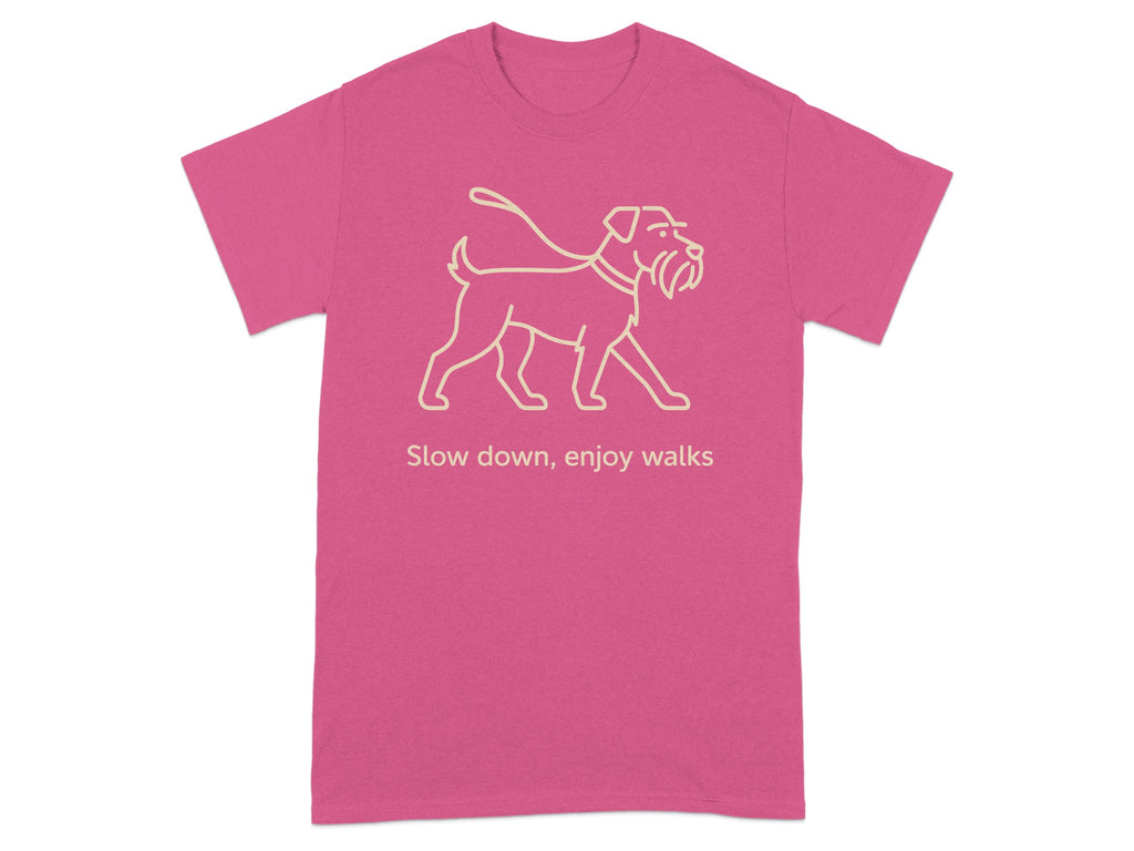 Pink t-shirt with a line drawing of a dog on a leash and the text "Slow down, enjoy walks."