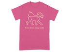 Pink t-shirt with a line drawing of a dog on a leash and the text "Slow down, enjoy walks."