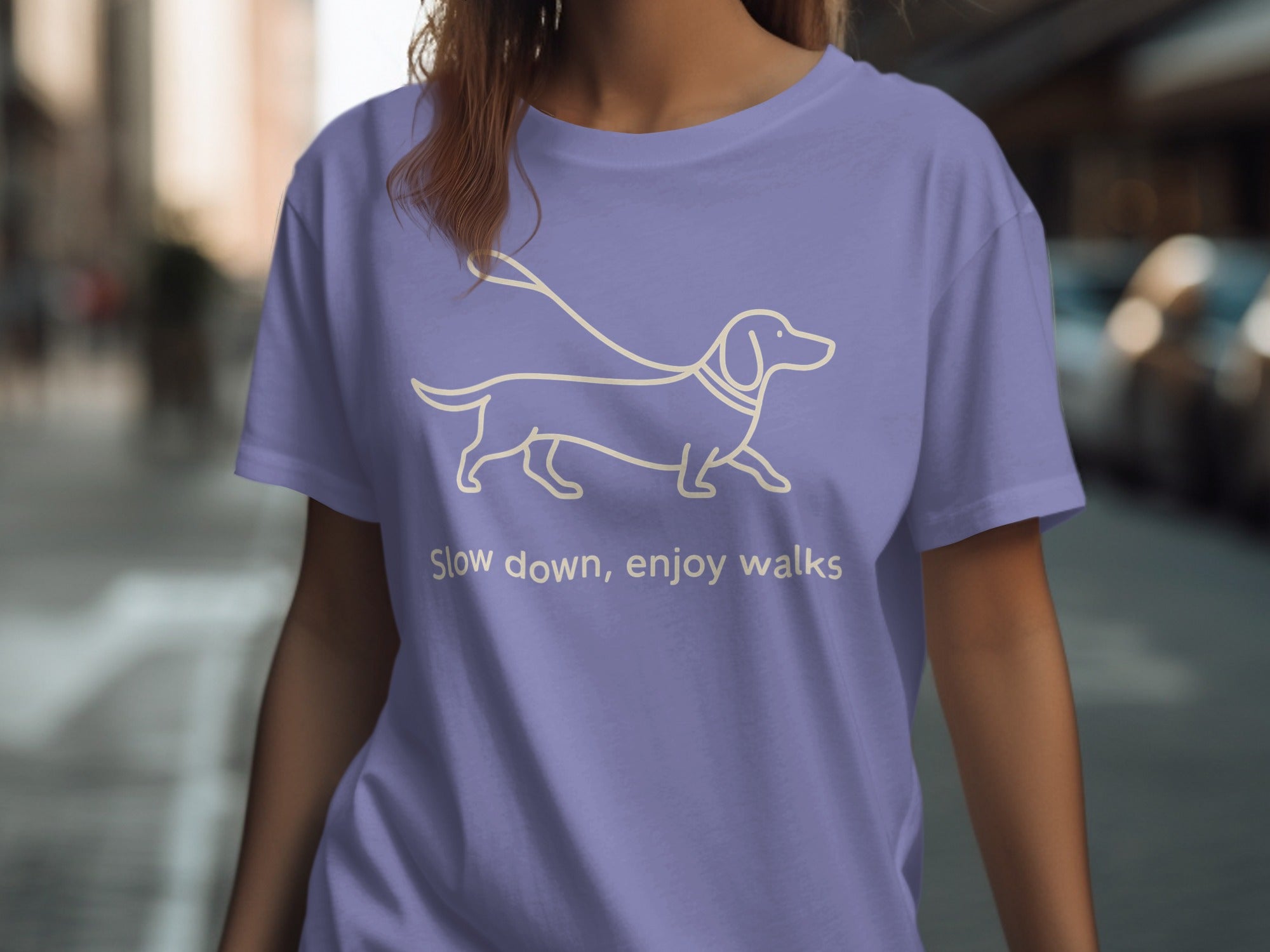 Purple t-shirt with outline of dachshund and leash, text "Slow down, enjoy walks".