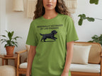 Green t-shirt with black cartoon dog and text "PERSONALLY VICTIMIZED BY LAB ZOOMIES".
