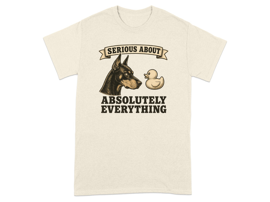 Cream t-shirt with Doberman and rubber duck graphic and text "SERIOUS ABOUT ABSOLUTELY EVERYTHING".